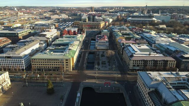 Trams Travelling At Ostra Hamngatan And Passing By Harbour Canal And Downtown Gothenburg, Sweden. - aerial
