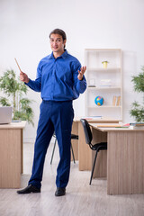 Young male teacher in front of white board