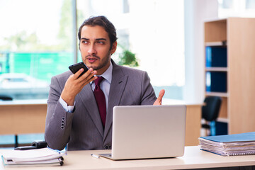 Fototapeta premium Young male employee working in the office