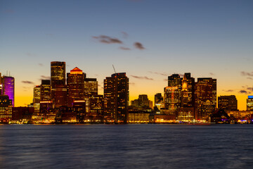 Naklejka premium Boston City Skyscrapers, Custom House and Boston Waterfront at sunset from East Boston, Boston, Massachusetts MA, USA.