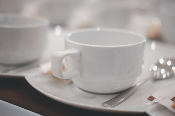Empty cups of coffee in a row at conference hotel