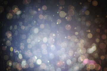 Abstract illustration of bokeh spots of light against black background