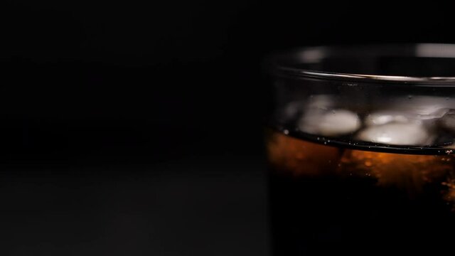 cola coke with ice cubes on cold glass 4k