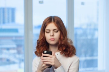 Fototapeta premium Business woman in white shirt with phone in hands communication technology office