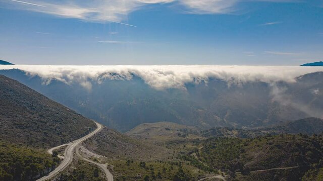 Aerial drone hyperlapse timelapse of rolling clouds over mountains in Spain in winter