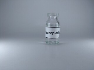 Word vaccine written in Polish language on a vaccine bottle 