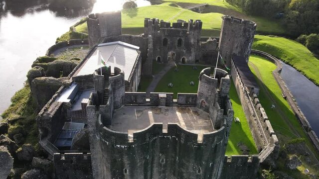 Welsh flag waving on gatehouse of Caerphilly Castle, United Kingdom, aerial view
