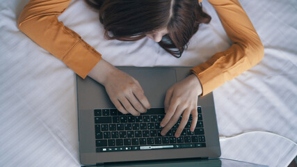 woman in the room lies on the bed laptop work lifestyle technology