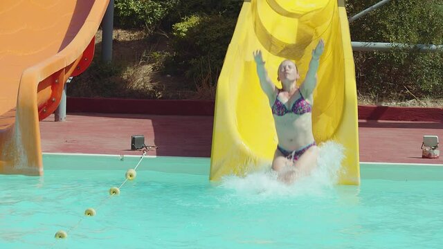 Young woman having fun on water slides