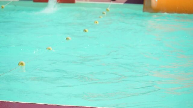 Young woman having fun on water slides
