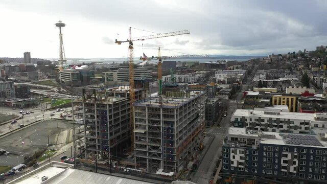 Cinematic aerial orbiting drone footage of construction near Westlake Park, Queen Anne, Eastlake and Capitol Hill looking from South Lake Union in Seattle, Washington during the COVID-19 pandemic
