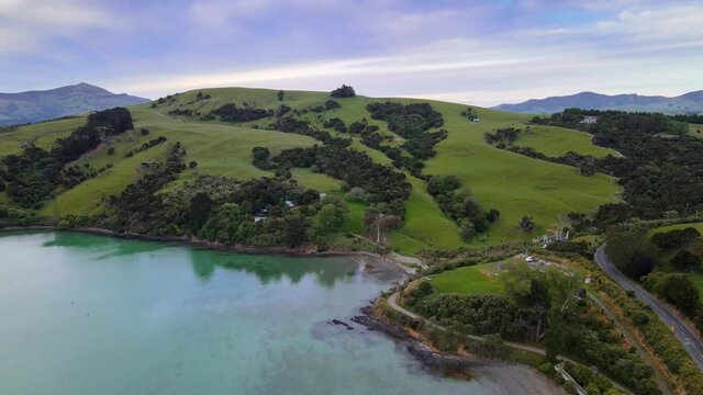 Aerial drone footage of sunset over Akaroa harbour on the Banks Peninsula, New Zealand.
