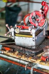 threading machine for iron pipes in a construction site.