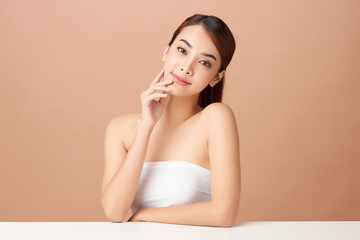 Beautiful young asian woman with clean fresh skin on beige background, Face care, Facial treatment, Cosmetology, beauty and spa, Asian women portrait