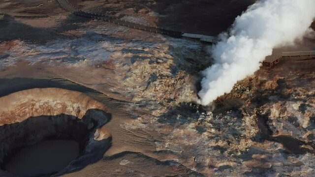 Thick steam rises from volcanic fumarole in wild Icelandic landscape, Gunnuhver
