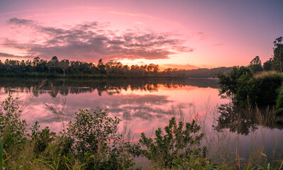 Panoramic Riverside Sunrise with Cloud Reflections