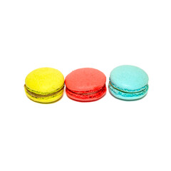Yellow Red Blue Macaroons isolated in white background. Colorful french macarons close-up. Tasty sweet color macaroon, bakery concept
