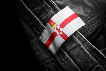 Tag on dark clothing in the form of the flag of the Northern Ireland