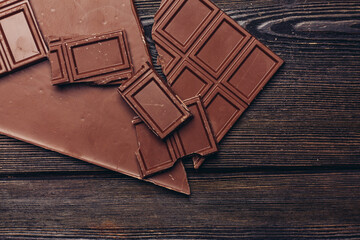 broken chocolate bar diagonal cubes texture wood background