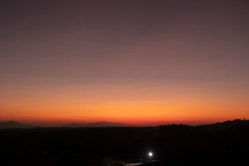 Morning blur over mountains and trees. The first and last light of the day in sky with beautiful