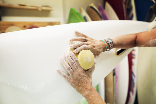 Cropped image of woman's hands making surfboard