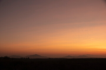 Morning blur over mountains and trees. The first and last light of the day in sky with beautiful