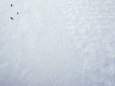 High angle view of people skiing on snow field