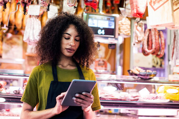 Owner using tablet computer at shop