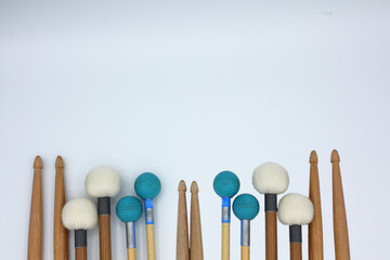 Percussion mallets set in the bottom on a white background with a text space.