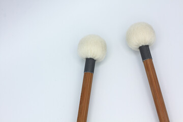 Detail of timpani mallets on a white background.