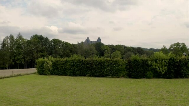 Empty benches for a garden wedding with castle ruins in the distance.