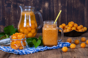 Healthy eating, food, dieting and vegetarian concept - mug glass of juice smoothie shake from yellow plum, lemonade, jam and ripe yellow plum