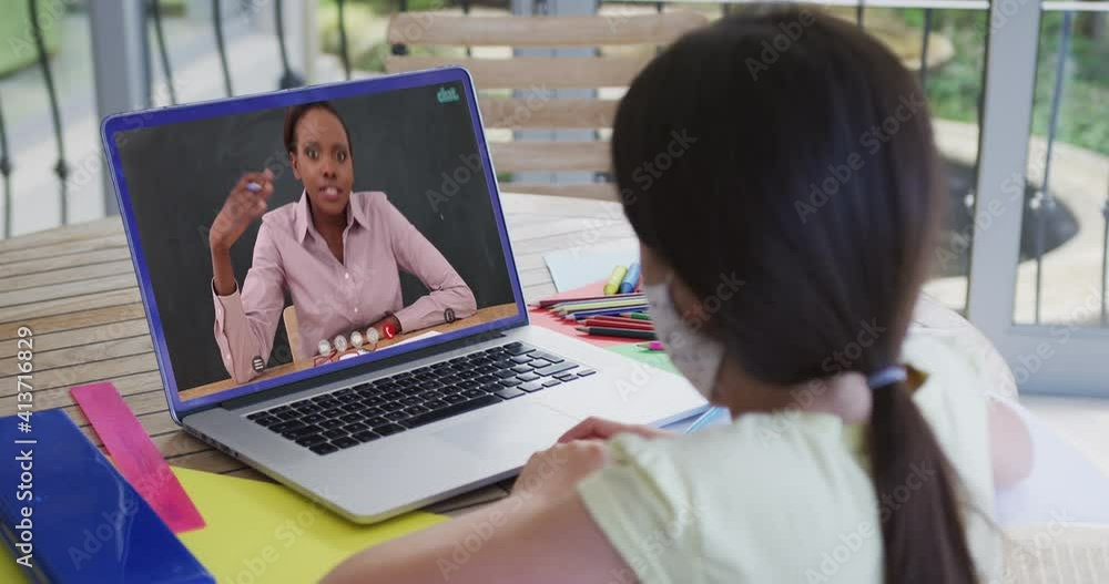 Poster Caucasian schoolgirl in face mask using laptop on video call with female teacher