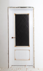 A door on the white wall in the room.