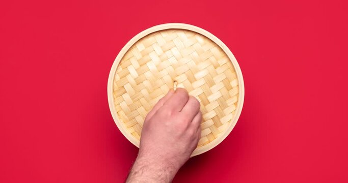 Baozi dumplings and bok choy, cooking process. Eating Chinese steamed food, 4k stop motion.Chinese baozi dumplings, cooking video stop motion animation. Steamed xiao long bao, top view, on red table.