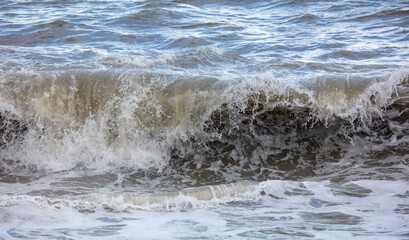 Fototapeta na wymiar Wave on the seashore as a background.