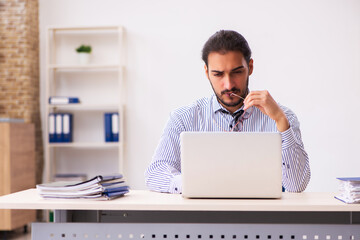 Young male employee working in the office