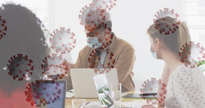Animation of floating covid-19 cells with colleagues in office wearing face masks