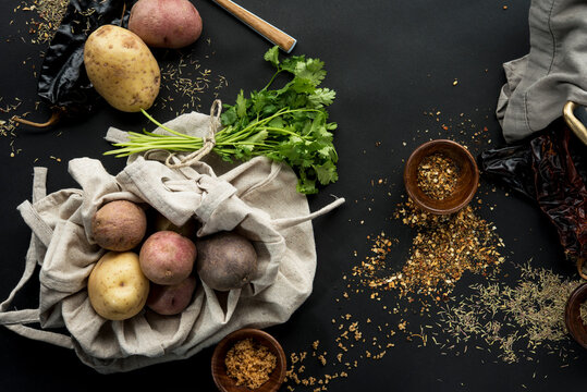 Overhead view of potatoes with cilantro and spices