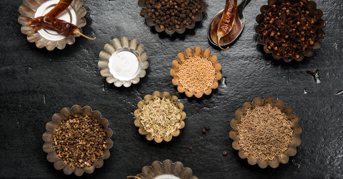 Overhead view of various spices in bowls on table