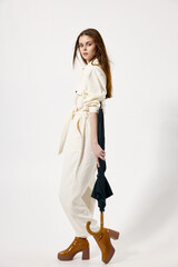 woman holding umbrella in hands white suits fashion