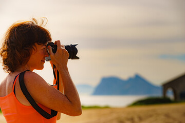 Tourist with camera on spanish coast.