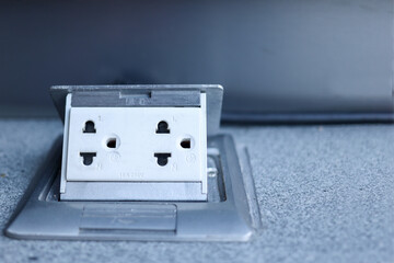 The power plug on the cement floor.Electrical equipment on the floor.