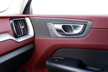 Naklejka premium Car door handle inside the luxury modern car with red leather texture with stitching. Switch button control. Modern car interior details. Red perforated leather