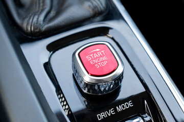 Car dashboard with focus on red engine start stop button. Modern car interior details. start/stop...