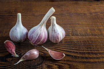 heads of garlic on a wood board. Rustic style