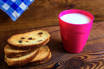 glass of milk, pastries on wood background