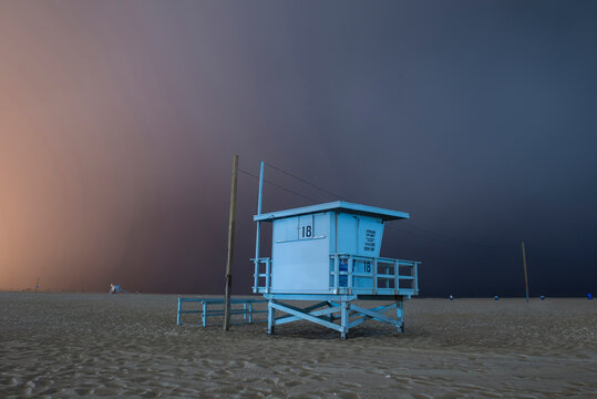 Lifeguard hut on sand against cloudy sky at Venice beach