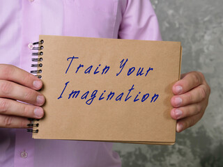 Motivational concept meaning Train Your Imagination with inscription on the piece of paper.
