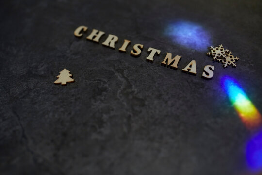 High angle view of Christmas text with decorations and light effect on table